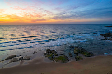 Obraz premium Aerial sunrise seascape with high cloud and gentle surf