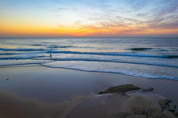Fototapeta na wymiar Aerial sunrise seascape with high cloud and gentle surf