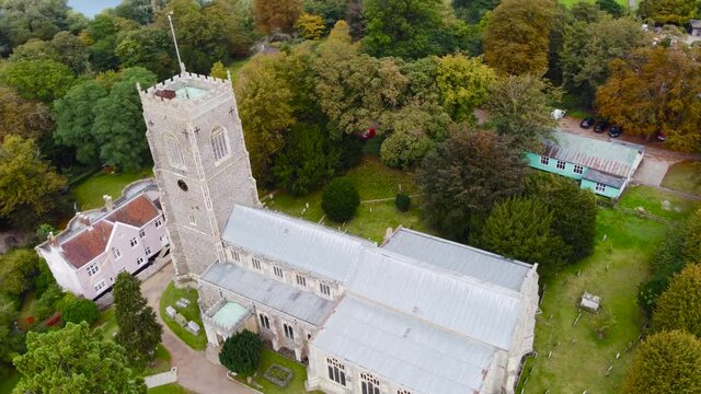 Aerial: St Michael's Church compound in Framlingham, England - drone tracking shot
