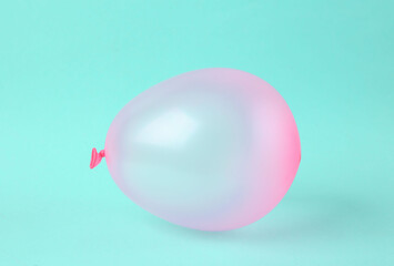 Pink balloon on bright blue background