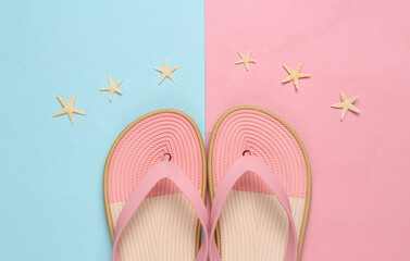 Colored flip flops on blue on pink pastel background