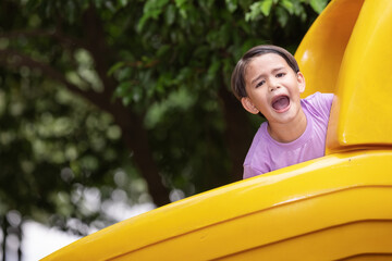 Little boy having fun while sliding.