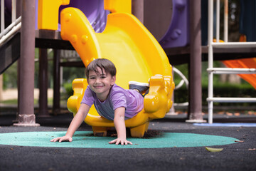 Little boy having fun while sliding.