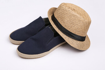 Mens straw hat and shoes on white background.