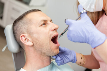 Obraz na płótnie Canvas Dentist prick anesthesia to man patient in dental clinic. Dental treatment concept