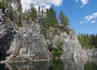A flooded tunnel in the steep slope of the Marble Canyon in the Ruskeala Mountain Park on a sunny summer day.