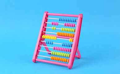 Plastic colored abacus on a blue background. Counting, education, economy, business and finance concept