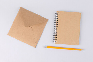 Craft notebook and envelope on white background