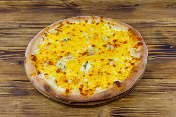 Pizza Four cheese on a wooden background