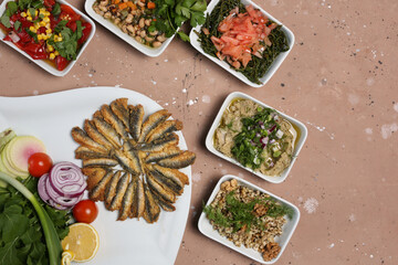 fish and appetizers on a white plate