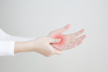 Close up women's hand with pain syndrome , rubbing inflamed hand.