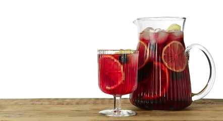 Glass and jug of Red Sangria on wooden table against white background. Space for text