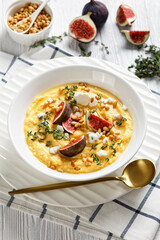 Pumpkin soup with feta, figs, pine nuts, top view