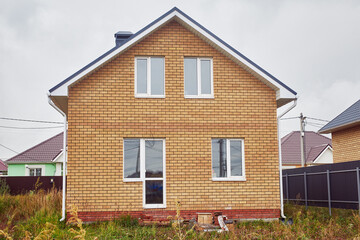A new two-storey brick house with a pitched roof.