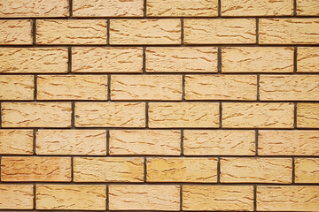 The texture of a yellow brick wall. Beautiful pattern background