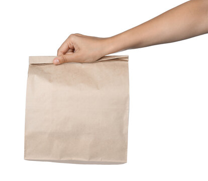 Woman holding paper bag on white background, closeup