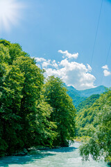 View of the mountain river in the gorge, North Ossetia, Russia. Impenetrable rocks, majestic mountains and forests.
