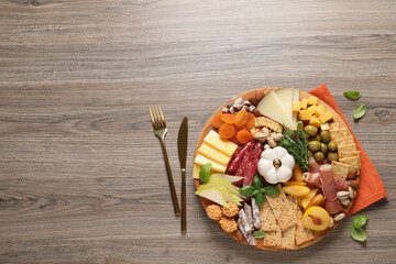 Different tasty appetizers on wooden table, flat lay. Space for text