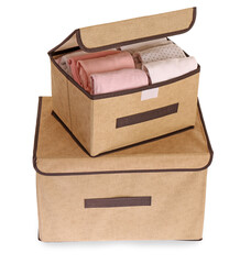 Textile storage cases with folded clothes on white background