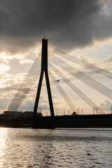 Fototapeta na wymiar Bridge over the Daugava River, Riga, Latvia, sunset landscape