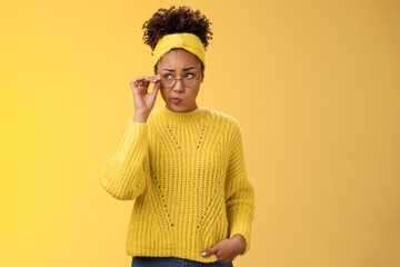 Unsure thoughtful hesitant cute african-american millennial teenage girl in round glasses sweater...