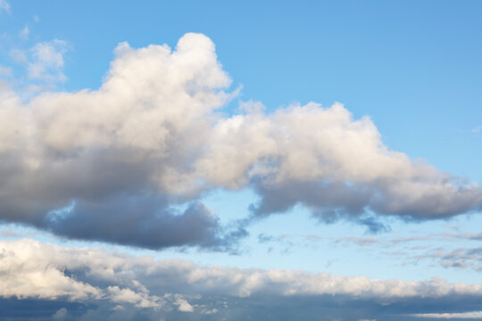 Beautiful fluffy clouds on warm sunny day © Elena