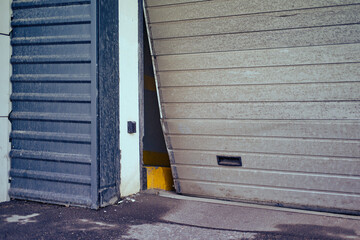 Broken garage for car exit, bent door close-up