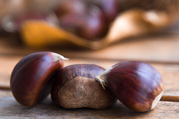 fresh chestnuts on wooden table