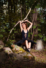 Relaxed Shy And Sexy Young Japanese Ballet Dancer in Black Tutu Posing in Summer Forest and Dreaming With Lifted Hands Behind.