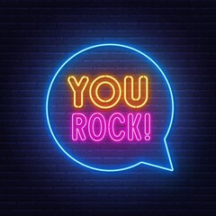 You Rock neon lettering on brick wall background.