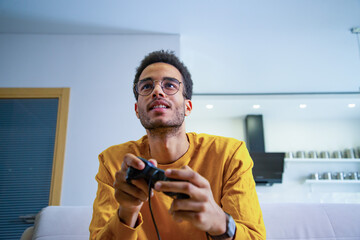 A young African playing a game of consoles © woff