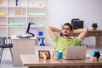 Young male designer working in the office