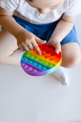 Baby playing with pop it toy, anti-stress toy, Tactile Soothing toy balls with Simple dimple close-up