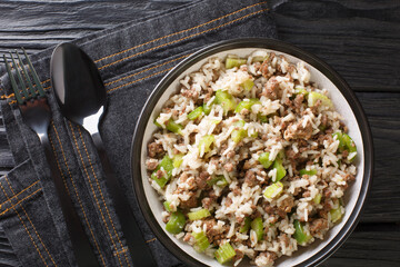Cajun dirty rice with chicken liver, minced meat, celery and pepper and close-up in a bowl on the table. horizontal top view from above