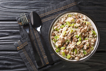 Louisiana Dirty Rice made with chicken livers and ground meat close-up in a plate on the table. Horizontal top view from above