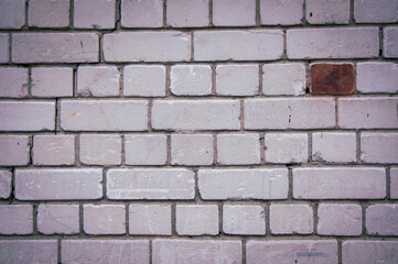 Painted in grey white colors old vintage empty brick wall background with copy space. Rustic cemented house stonewall texture with grunge surface. Shabby Building Facade With Damaged Plaster