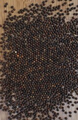 large number of black peppers seeds top view, selective focus