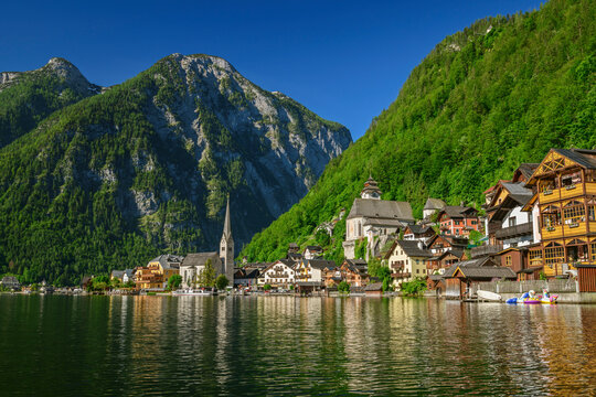 Scenic view of lake by Hallstatt town against clear sky