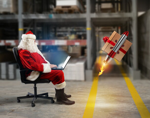 Santa claus delivers online orders from a laptop