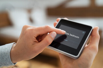 Woman using touch screen smart home device