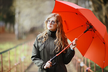 seasonal autumn portrait, sad girl with umbrella, november seasonal virus immunity on a walk - obrazy, fototapety, plakaty