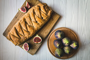 Rustic pie with figs and apples on a wooden board.
Homemade delicious fig cake.
