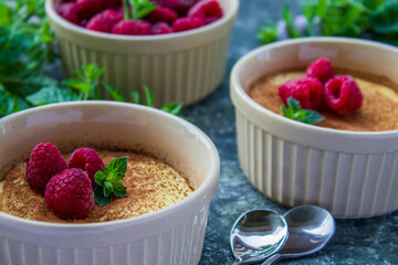Cheese soufflé with raspberries on a dark background, close-up, simple composition
