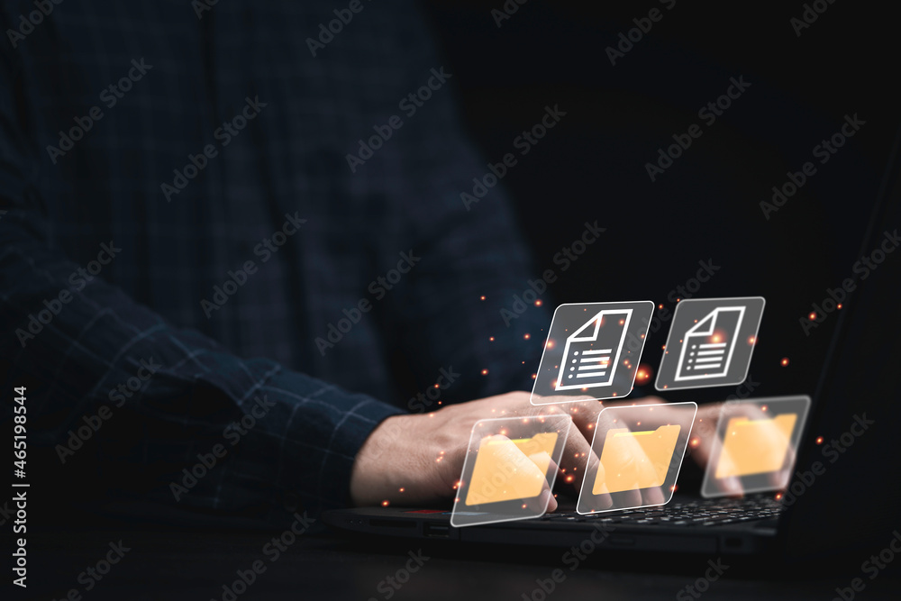 Aufkleber Businessman using computer laptop with virtual folder graphic for online document database management concept.