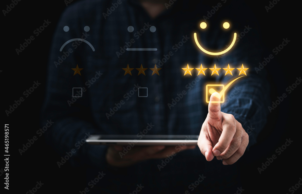 Poster Customer holding tablet and touching to tick sign on virtual smiley face for client evaluate after use product and service concept.