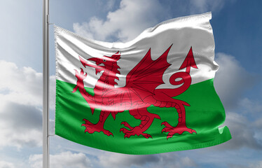 The Welsh flag against a blue sky. Motion blur at the tip of the flag. Space for text in the sky.
