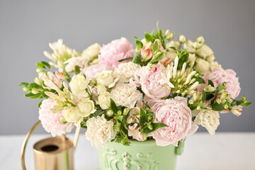 Beautiful flower arrangement in a green ceramic vase. Flowers bunch, set for interior. Fresh cut flowers for decoration home. European floral shop. Delivery fresh cut flower.v