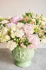 Beautiful flower arrangement in a green ceramic vase. Flowers bunch, set for interior. Fresh cut flowers for decoration home. European floral shop. Delivery fresh cut flower.v