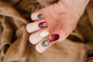 Beautiful matte muted color nails close-up, glittery nail art manicure.