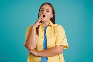 Young white woman wearing shirt posing and yawning at camera